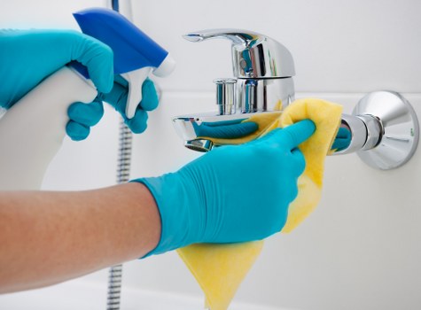 Professional carpet cleaner checking a room for hazards